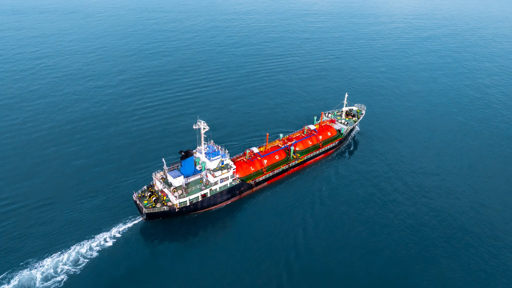 Aerial view of an LPG gas tanker ship navigating deep blue ocean waters