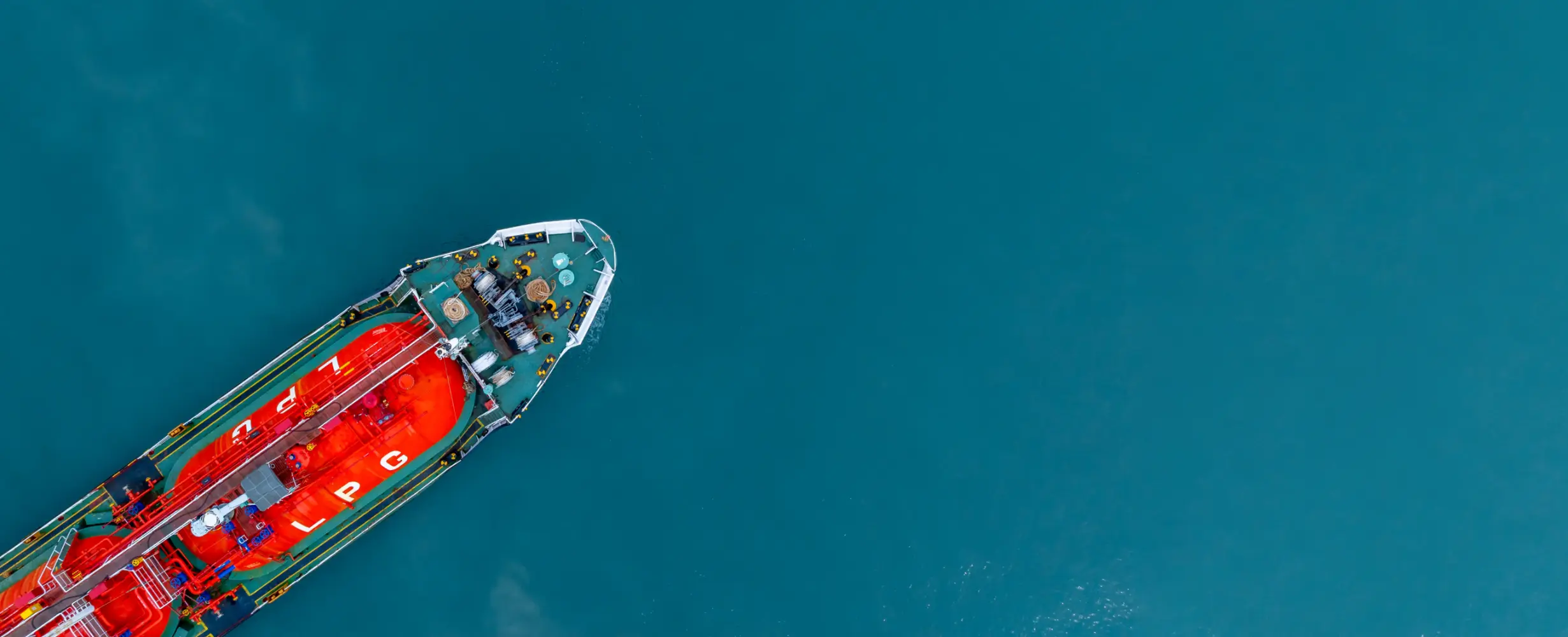 Top-down view of an LPG gas tanker ship in deep blue sea waters