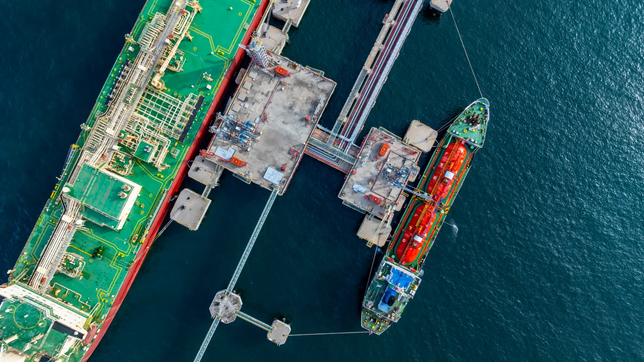 Aerial view of an LPG tanker vessel loading and unloading cargo at a marine terminal